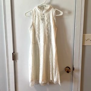White knee length dress with lace details. Great for sorority events or brides.